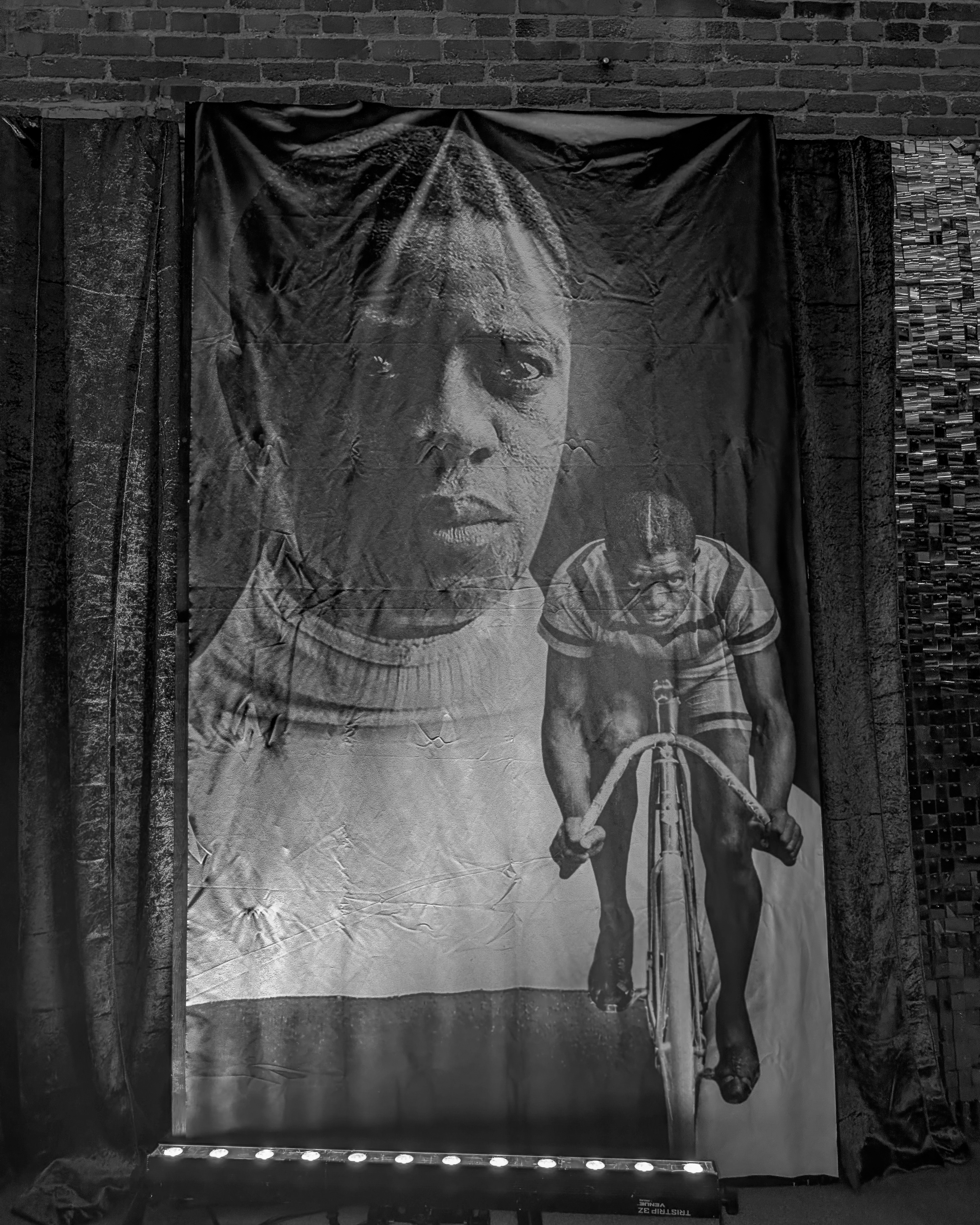 Large black and white portrait banner of Marshall Major Taylor displayed at Bay 7 during the MTICA 2026 Legacy Dinner in Durham NC