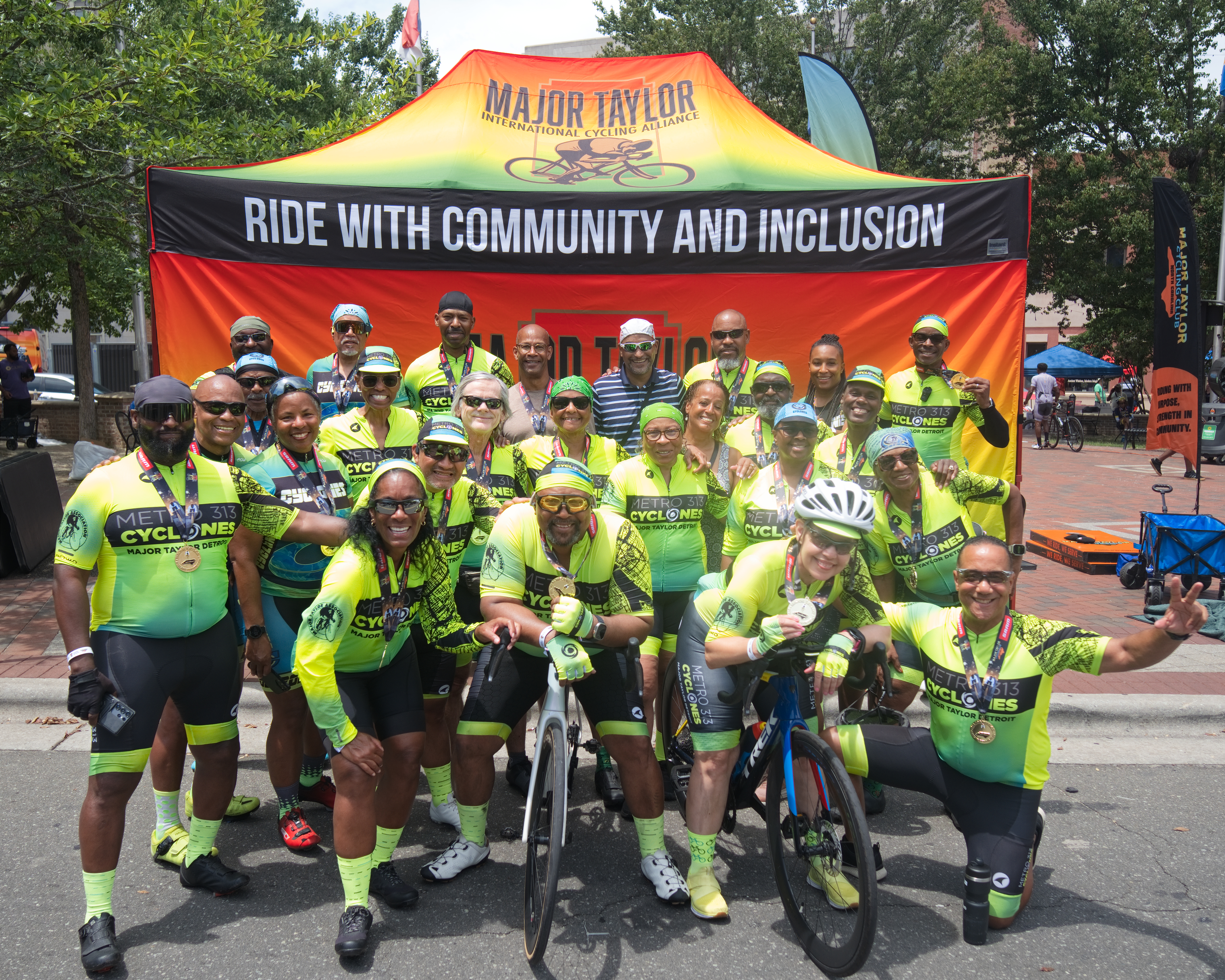 Metro 313 Cyclones Major Taylor Detroit cycling club members celebrating with finisher medals at the MTICA 2026 Convention Finish Line Festival in Durham NC