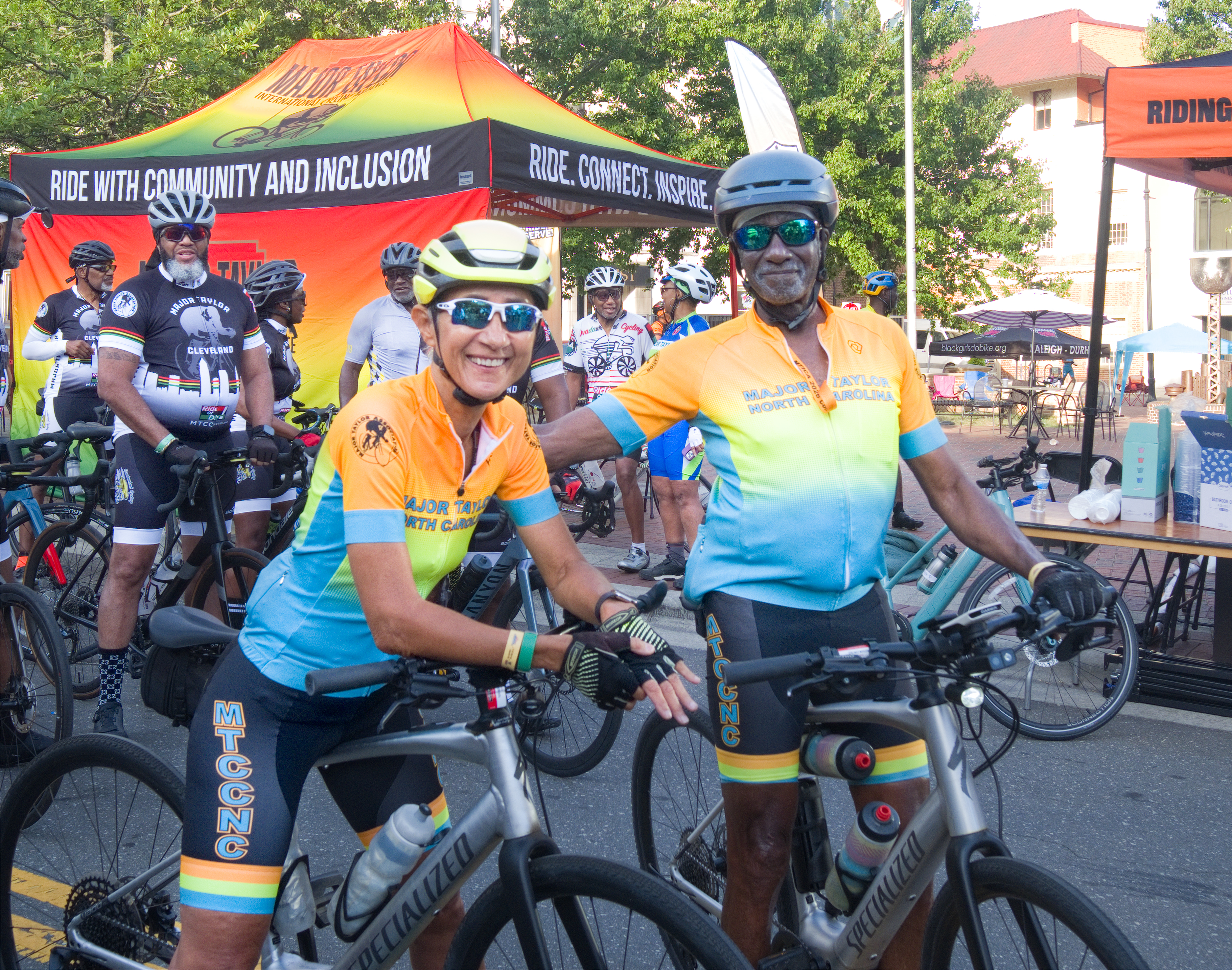 Major Taylor Cycling Club North Carolina MTCCNC host club riders in orange and teal jerseys at the start line for the MTICA 2026 Convention in Durham NC