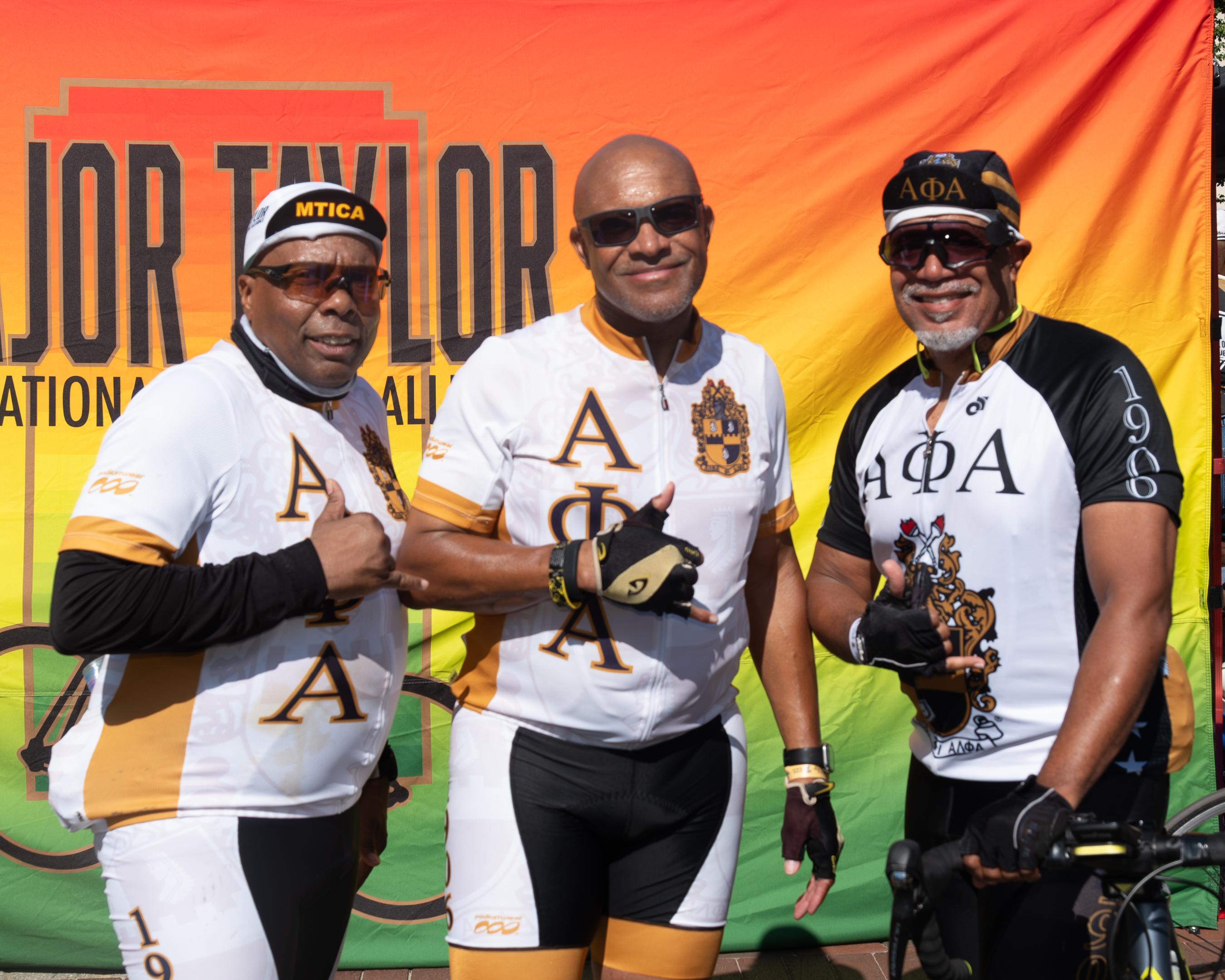 Alpha Phi Alpha fraternity members in matching cycling jerseys at the MTICA 2026 Convention start line in Durham NC