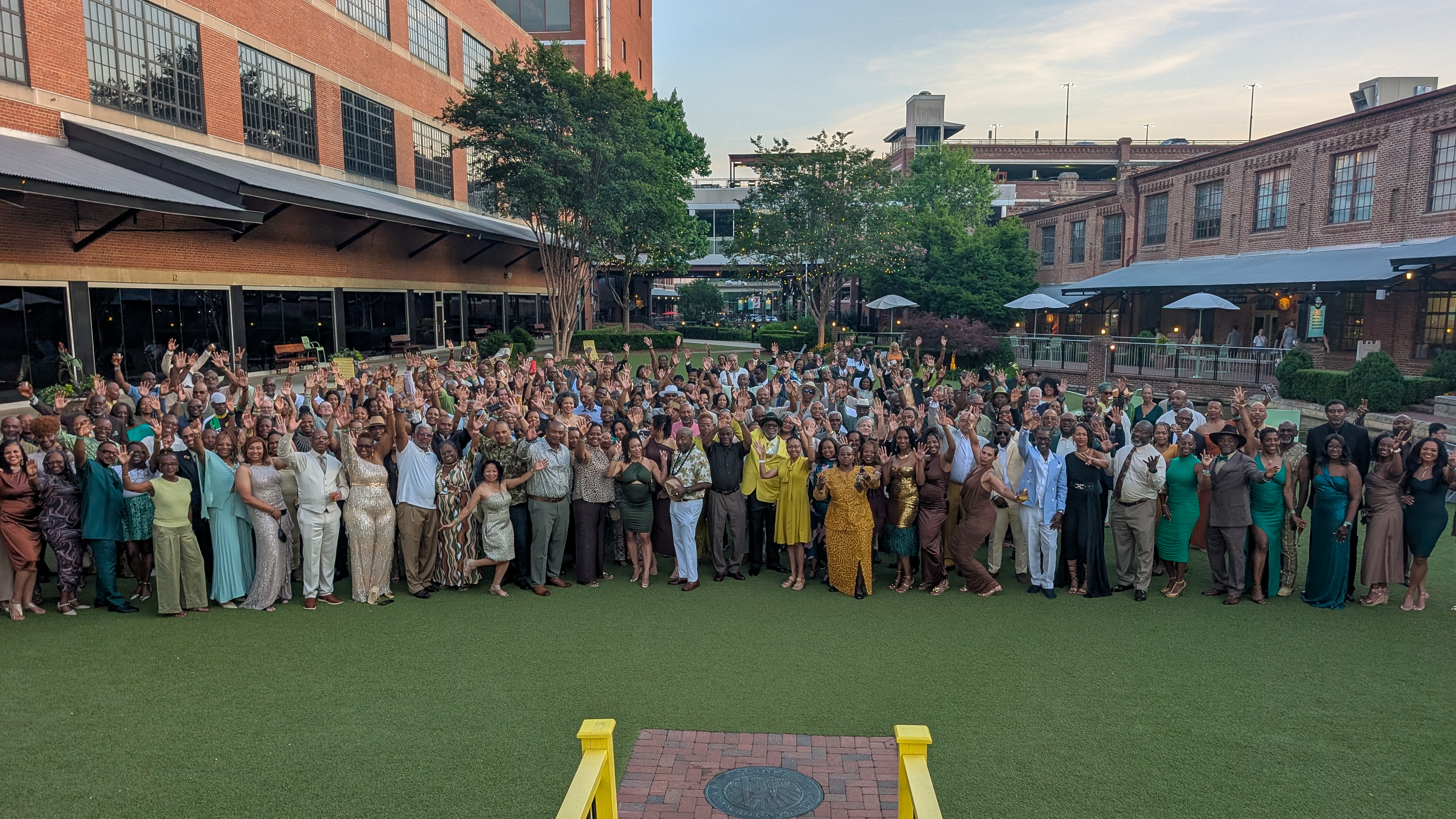 Hundreds of MTICA 2026 Convention attendees dressed in green gold and brown celebrating the Major Taylor Legacy Dinner at Bay 7 in the American Tobacco District in Durham NC
