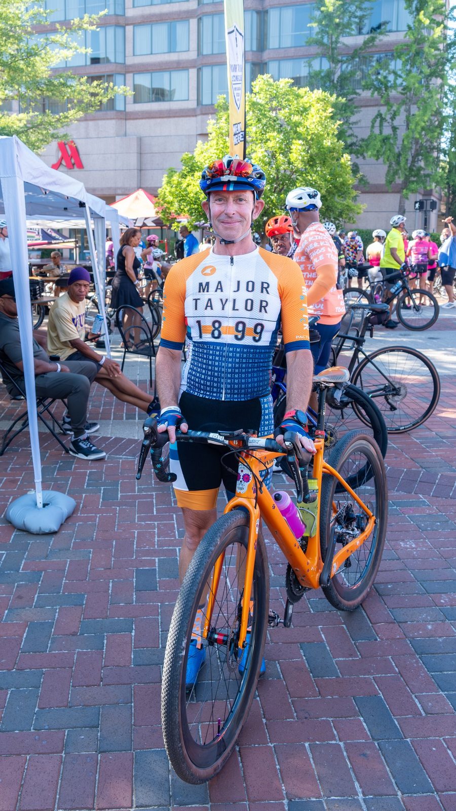 Cyclist wearing Major Taylor 1899 jersey with orange bike at CCB Plaza during the MTICA 2026 Convention in Durham NC