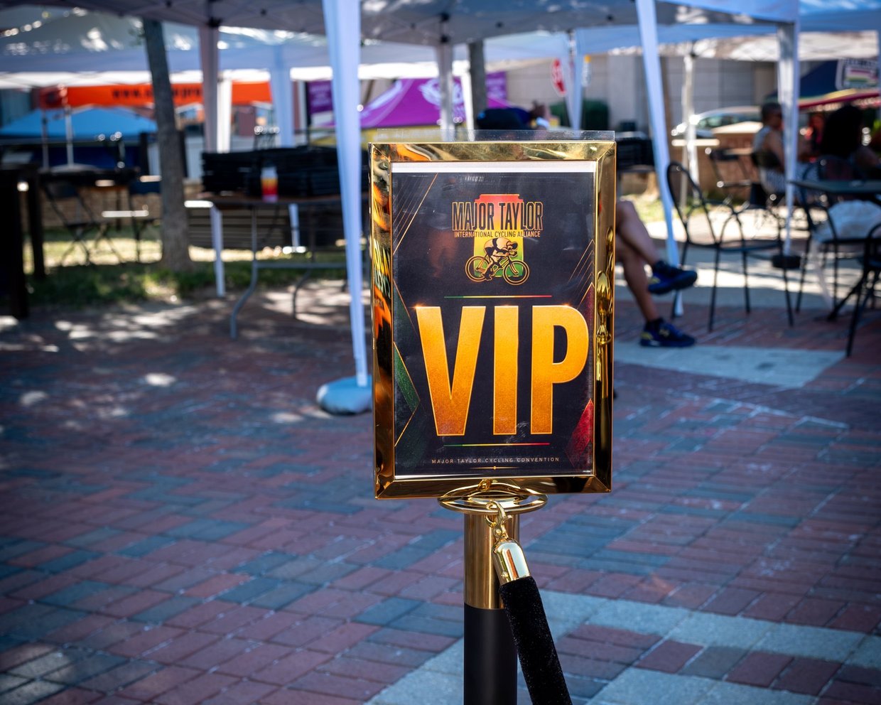 Gold-framed VIP sign on rope stanchion at the MTICA 2026 Major Taylor Cycling Convention at CCB Plaza in Durham NC