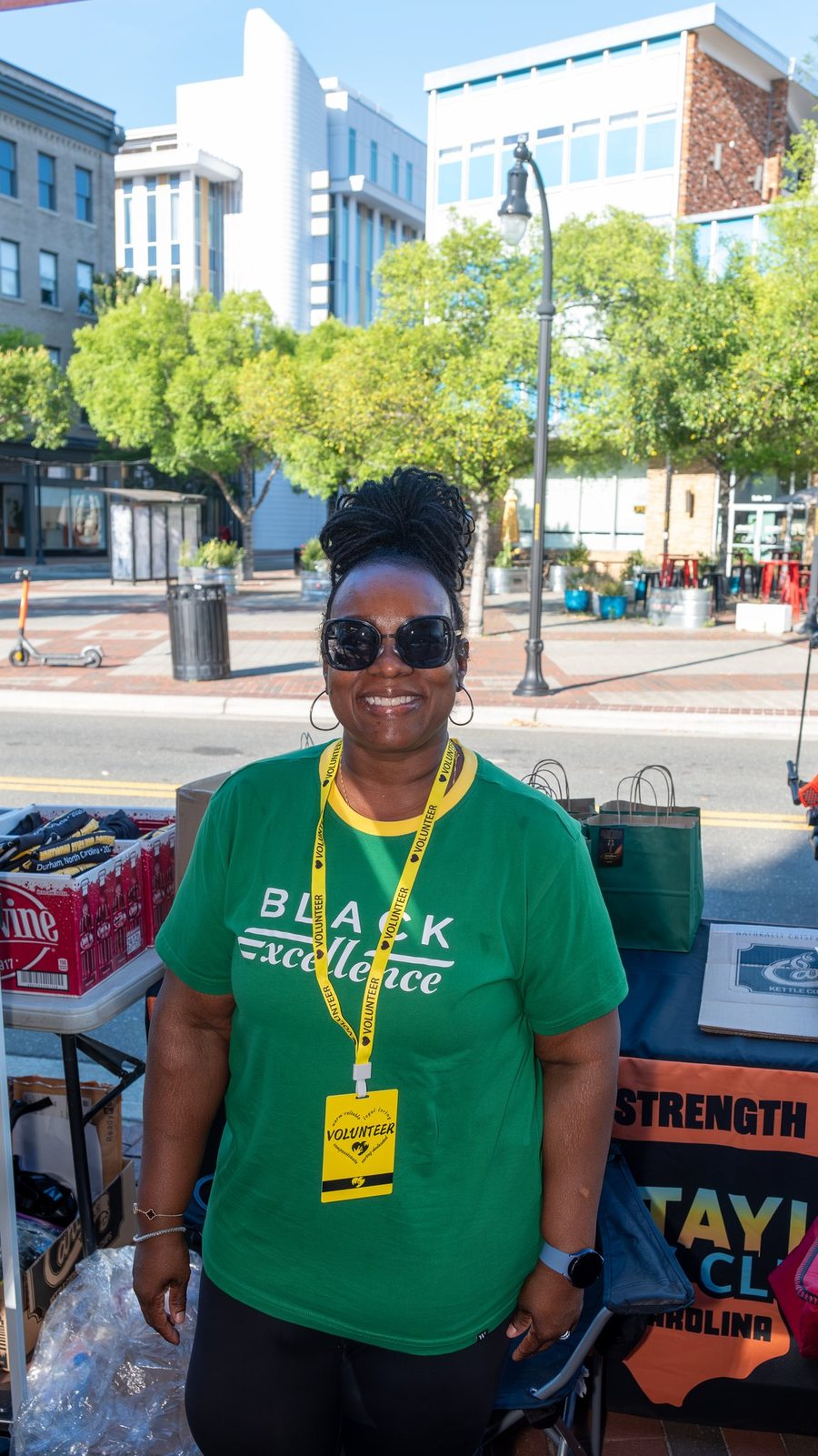 MTICA 2026 Convention volunteer in Black Excellence shirt at the packet pickup station in downtown Durham NC