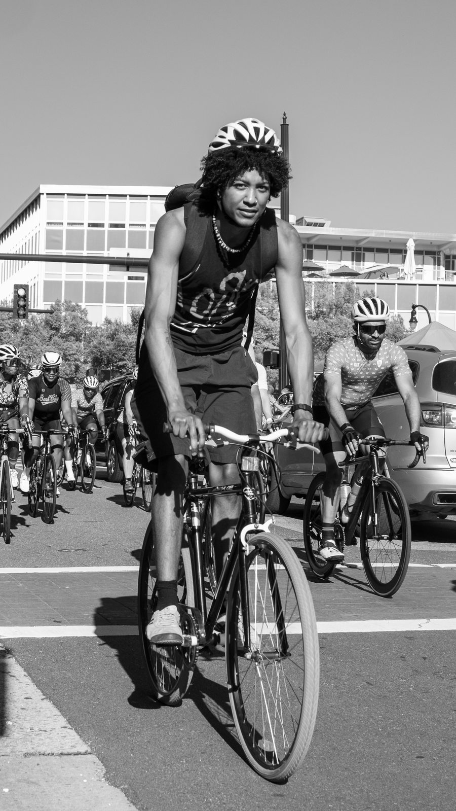 Young cyclist riding through downtown Durham streets during the MTICA 2026 Major Taylor Cycling Convention
