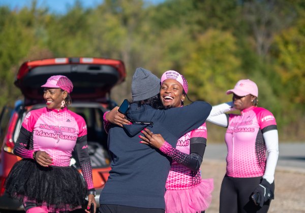 Riders embracing at the Major Miles for Mammograms community ride