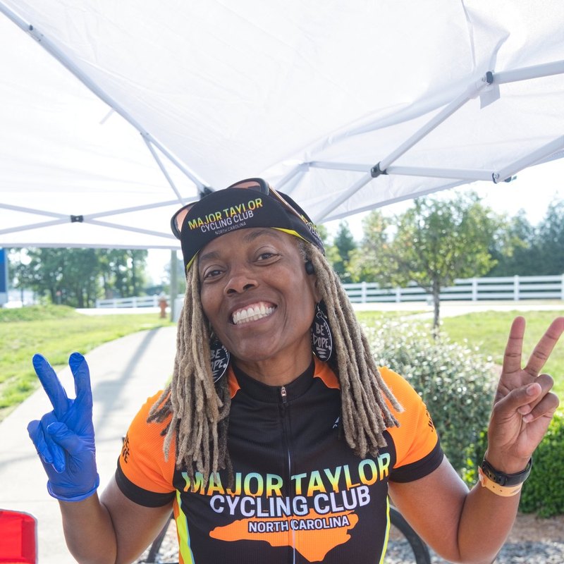 A Major Taylor Cycling Club member celebrating at a ride